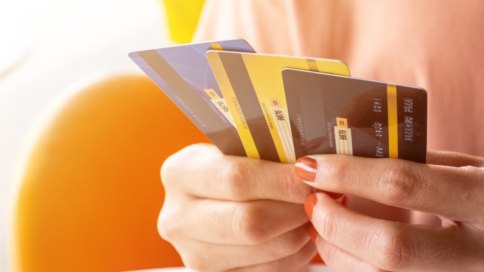 Woman holding 3 credit cards