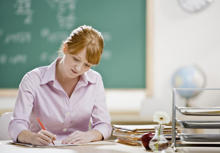 A female teacher writing a lesson plan