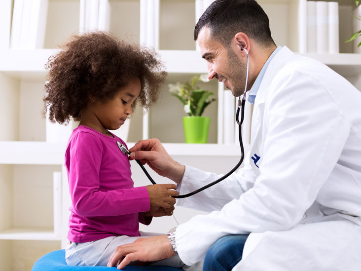 Doctor performing a cardiovascular exam with stethoscope on a pediatric patient