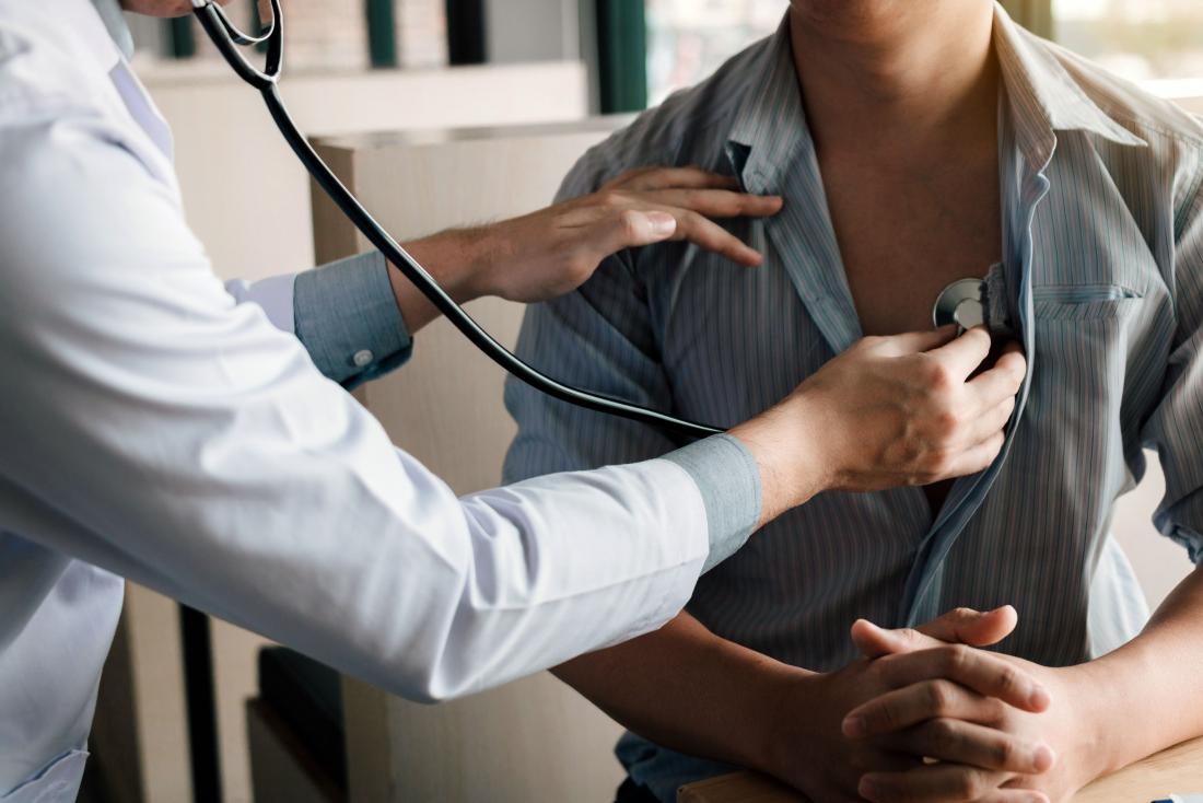 Doctor performs physical examination on patient with stethoscope