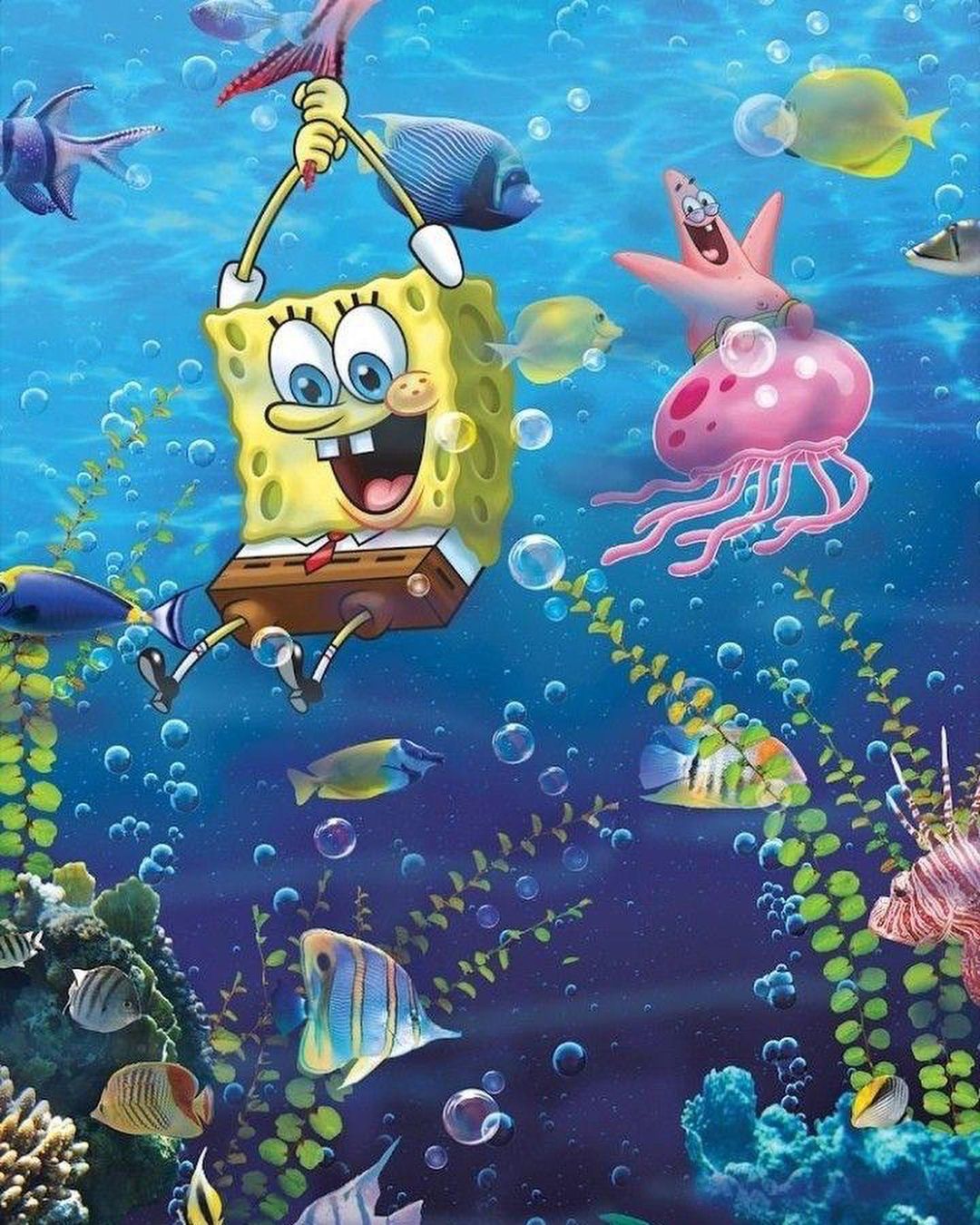 SpongeBob clings on a tail of a fish and Patrick rides on a giant pink jellyfish as different fishes swim everywhere