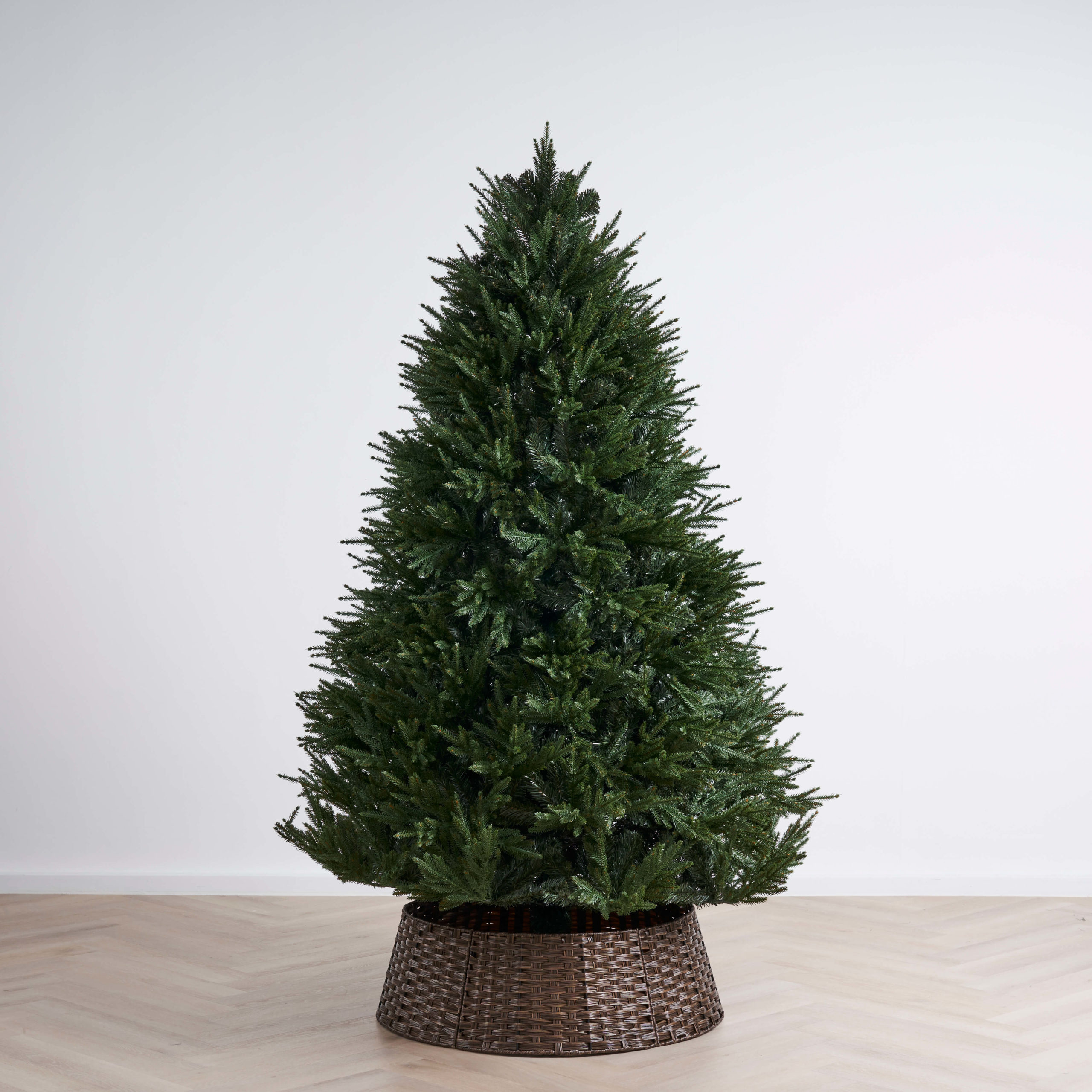 Small balsam fir Christmas tree placed on a dark brown pot