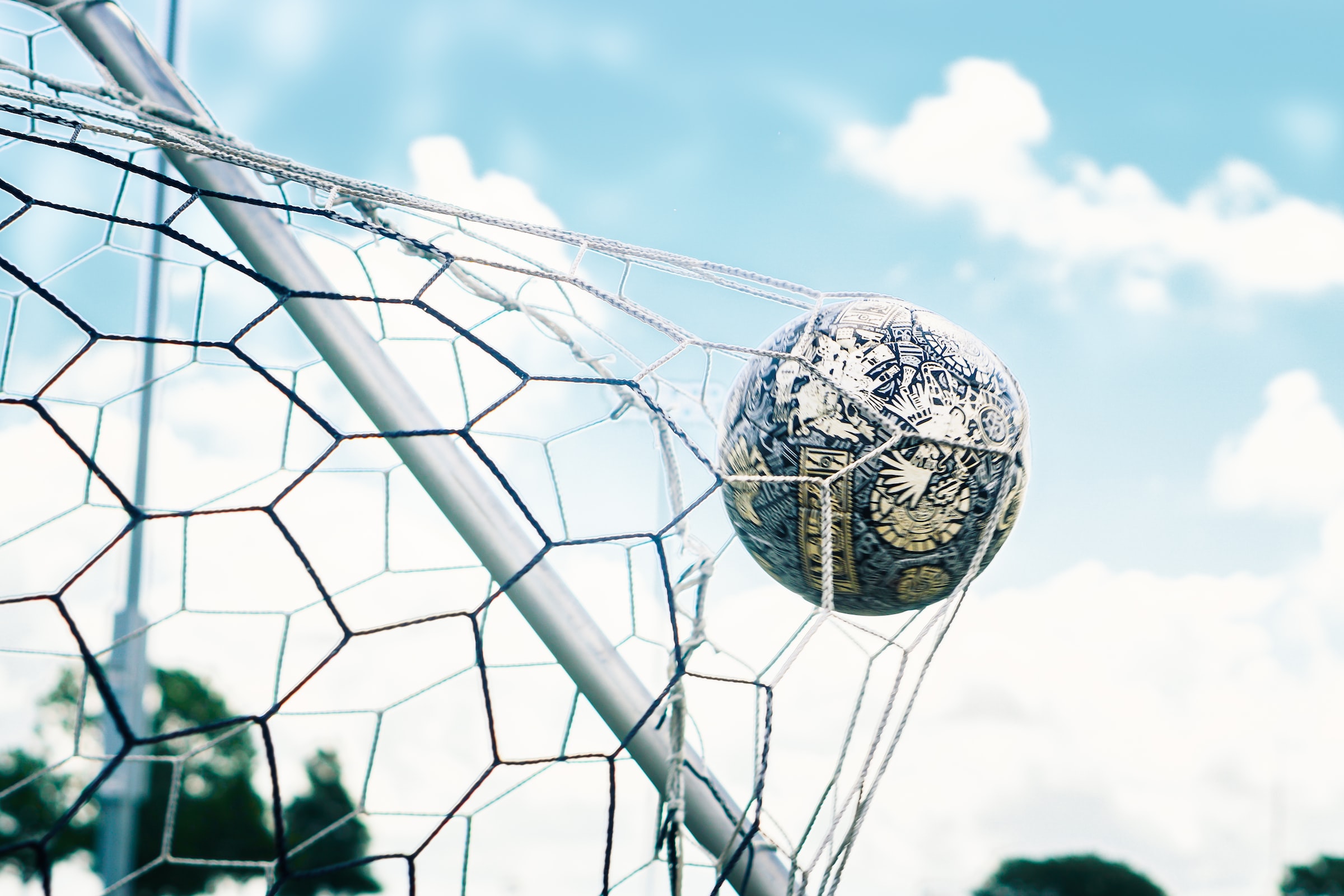 Football ball in the net of the goalkeep