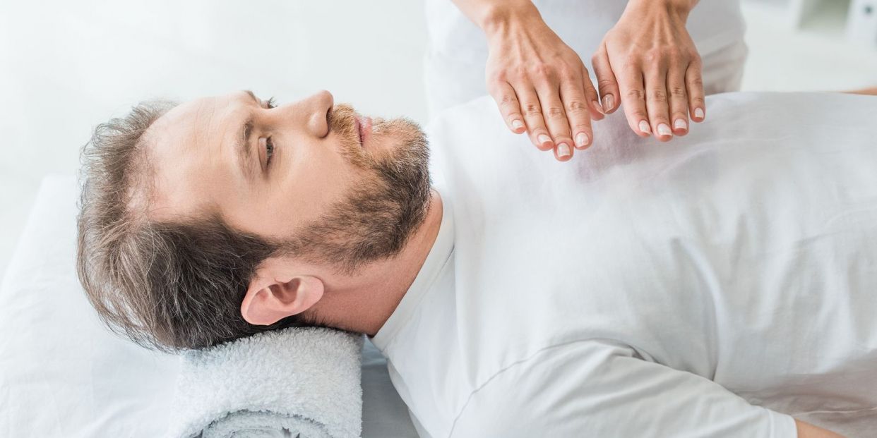 Sleeping man in a reiki session